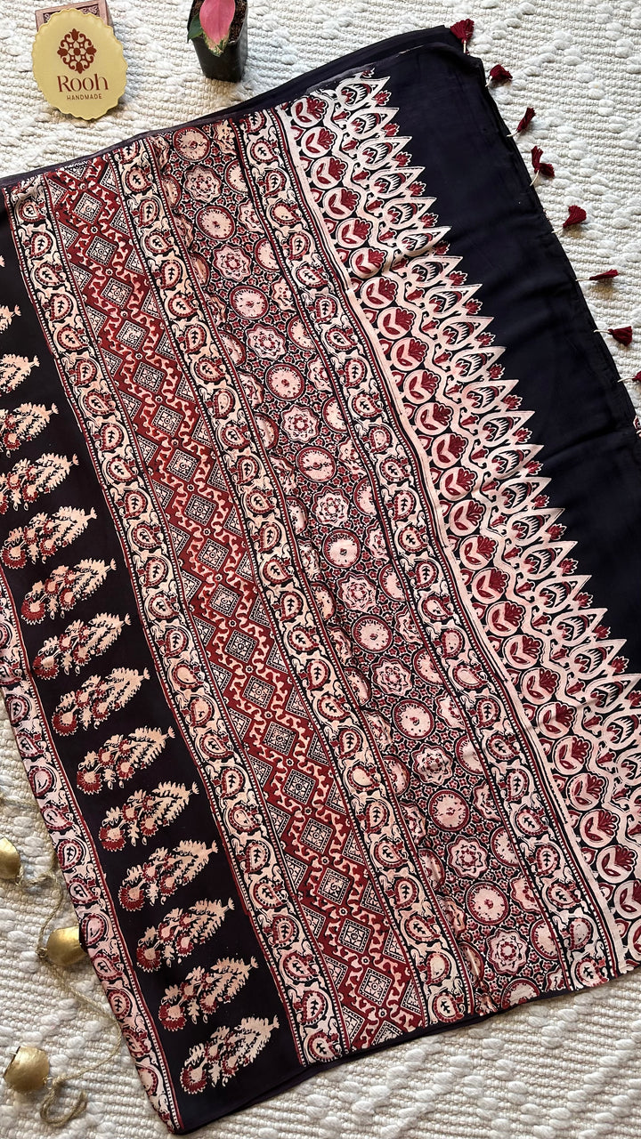 BLOSSOMS ON MIDNIGHT BLACK- SUPER PREMIUM & BUTTERY SOFT AJRAKH HAND BLOCK PRINTED MODAL SILK SAREE
